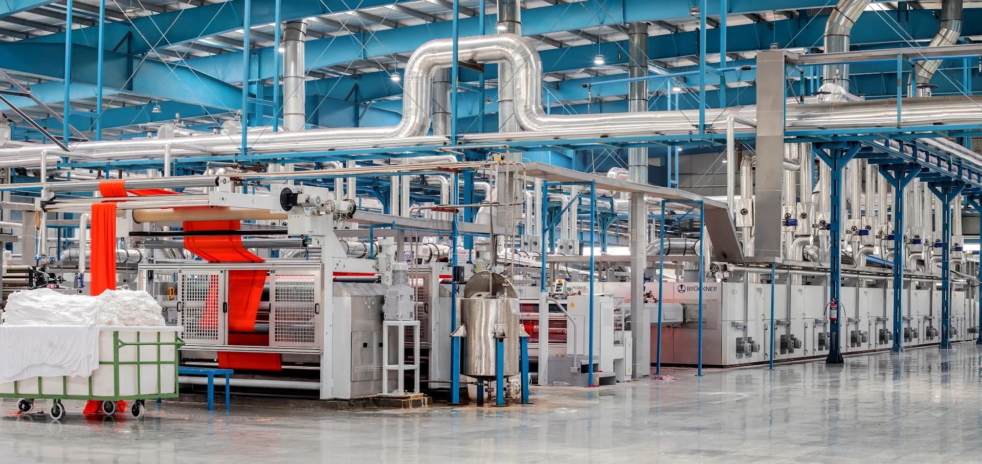 A large commercial facility with a glossy, well-maintained concrete floor — the kind of hard floor a winter salt-and-grit routine is meant to protect