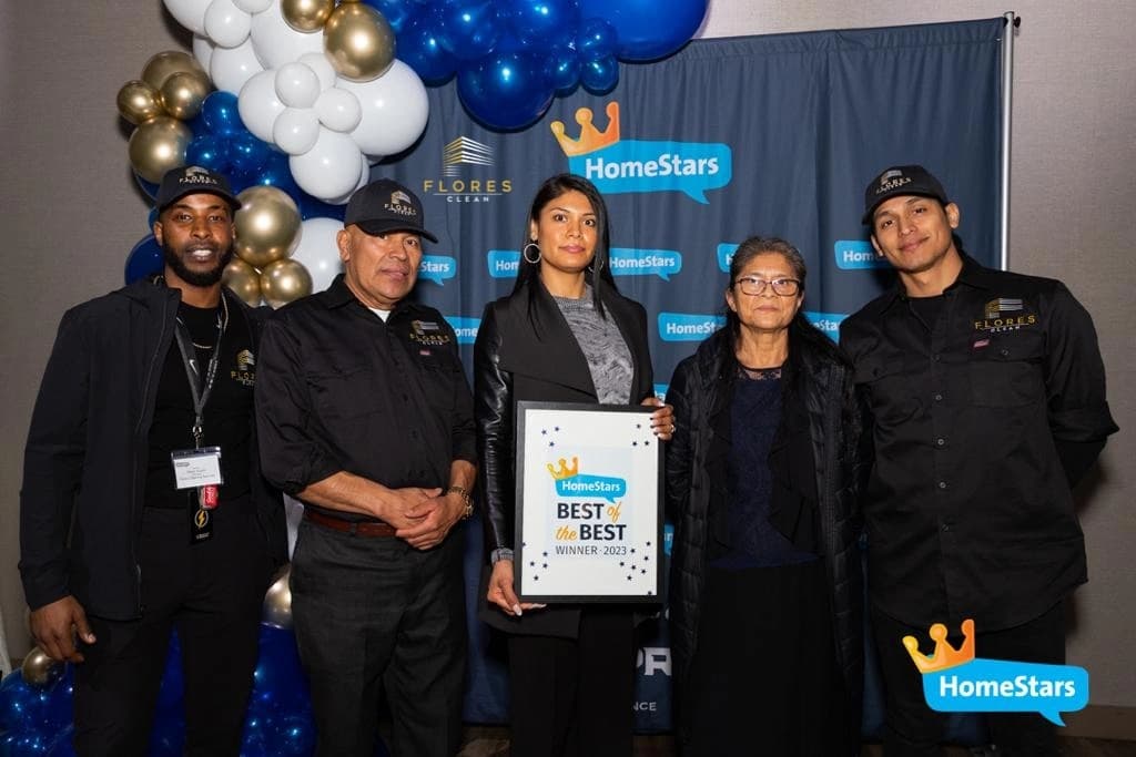 Five Flores Clean team members holding their HomeStars Best of the Best 2023 award in front of a HomeStars backdrop
