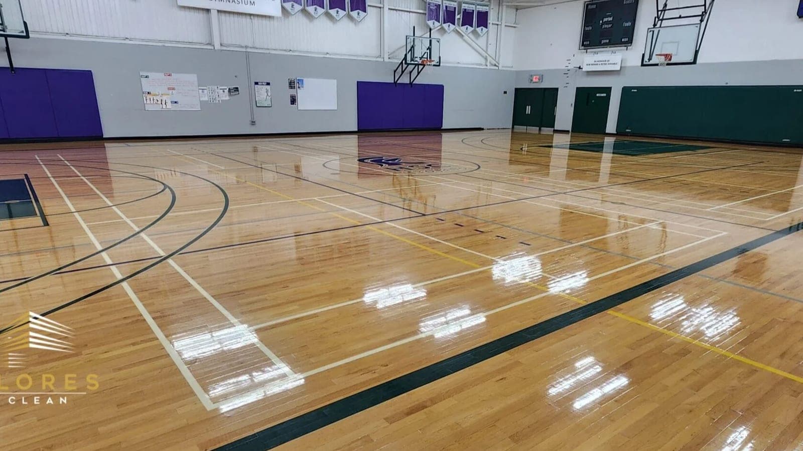 A freshly refinished high-gloss gymnasium floor